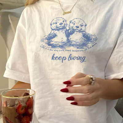 Women's Casual Short Sleeve T-Shirt with Two Otters & "Keep Loving" Graphic - White with Blue Water Ripple Design, Medium Stretch Round Neck Top for Spring Summer Fall, Machine Washable, Ladies T Shirts, Everyday Clothing, Re